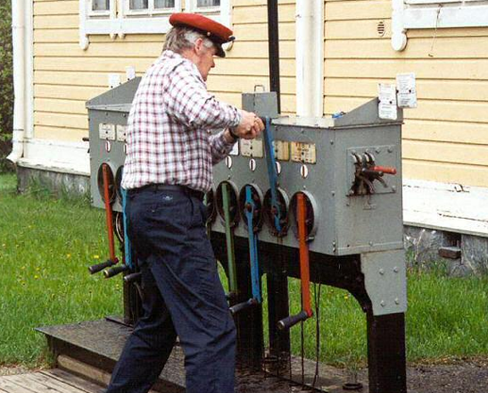 man moving levers on a machine